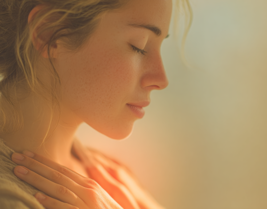 Close de uma mulher de perfil, com os olhos fechados em expressão de paz, se abraçando. Uma luz quente e dourada brilha de seu peito, simbolizando o amor-próprio e a cura da dependência emocional.